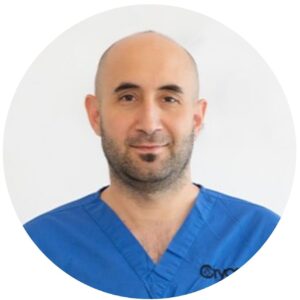 Cryos IVF Clinic 1 Portrait of Christodoulos Christodoulou, MSc, Operations Manager and Expert Embryologist at Cryos IVF Clinic, wearing blue medical scrubs.