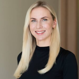 Clinic EGV 1 Portrait of Marta Slaidina, CEO and Medical Director of EGV Clinic, wearing a black top with long blonde hair.