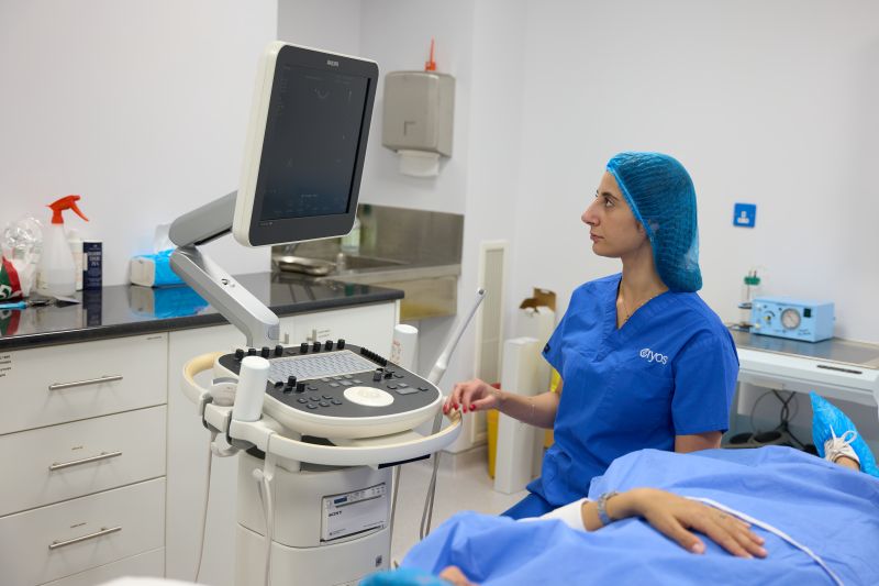 Cryos IVF Clinic 5 Medical professional performing an ultrasound scan at Cryos IVF Clinic in Cyprus, showing advanced equipment and patient care in a clinical setting.