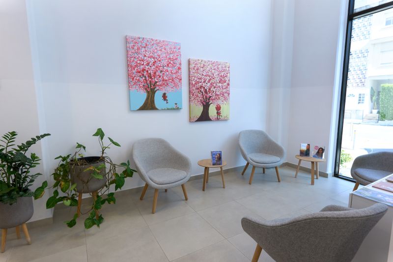 Cryos IVF Clinic Modern waiting room at Cryos IVF Clinic in Cyprus, featuring comfortable chairs, indoor plants, and wall art creating a welcoming environment for patients.